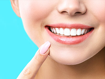 The image features a close-up of a person s face with a bright smile, showcasing dental hygiene products such as toothpaste and mouthwash.